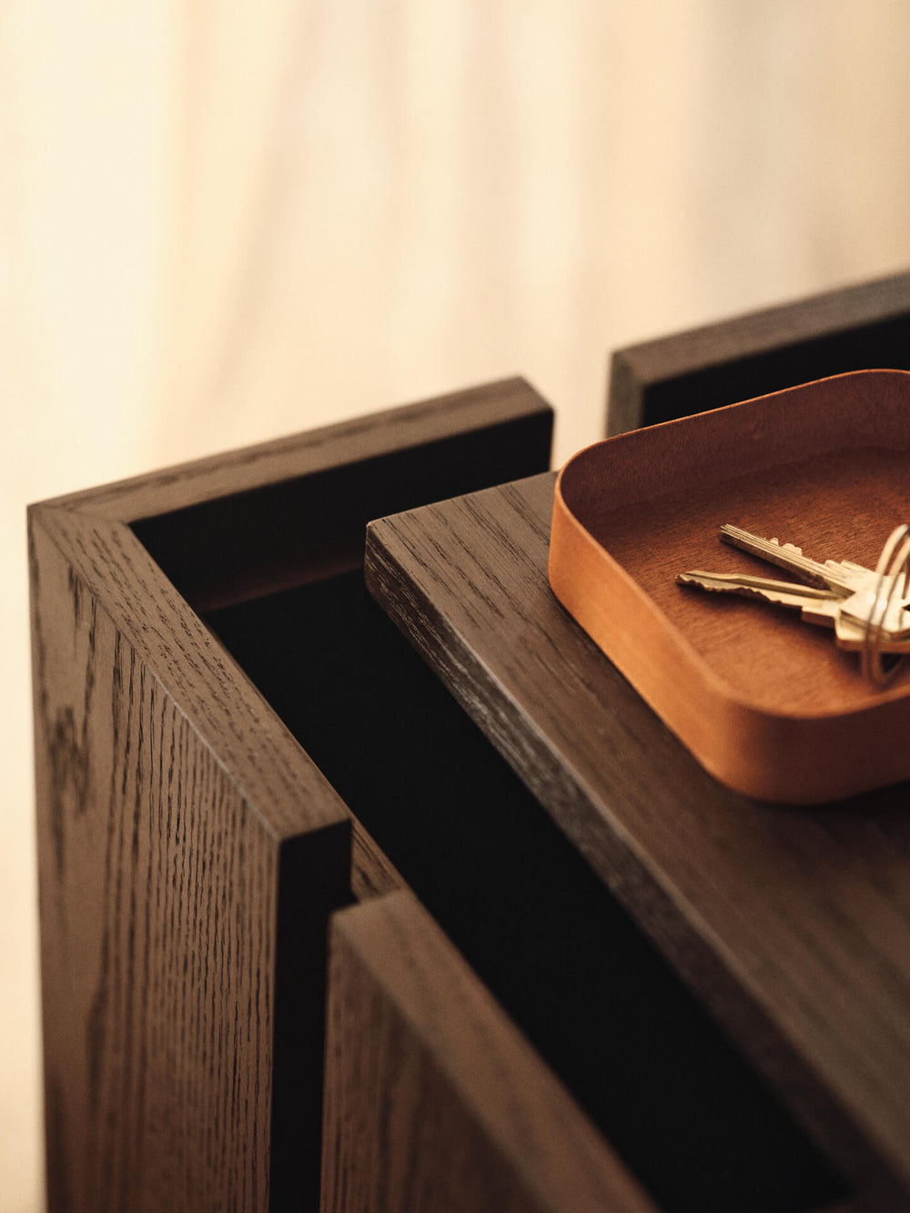 Close-up of the open top compartment, with a small tray holding keys on the edge