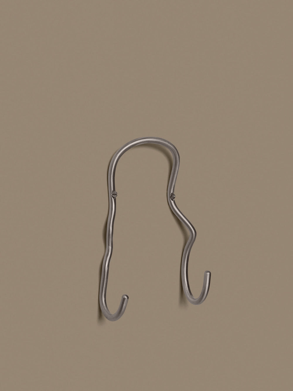 Wall-mounted double hook with two curved arms, screwed to the wall