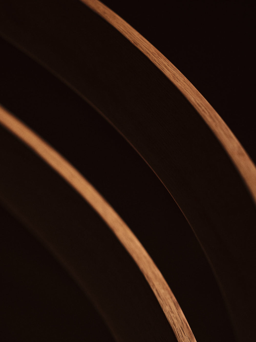 Close-up of the curved double-rail backrest in low light