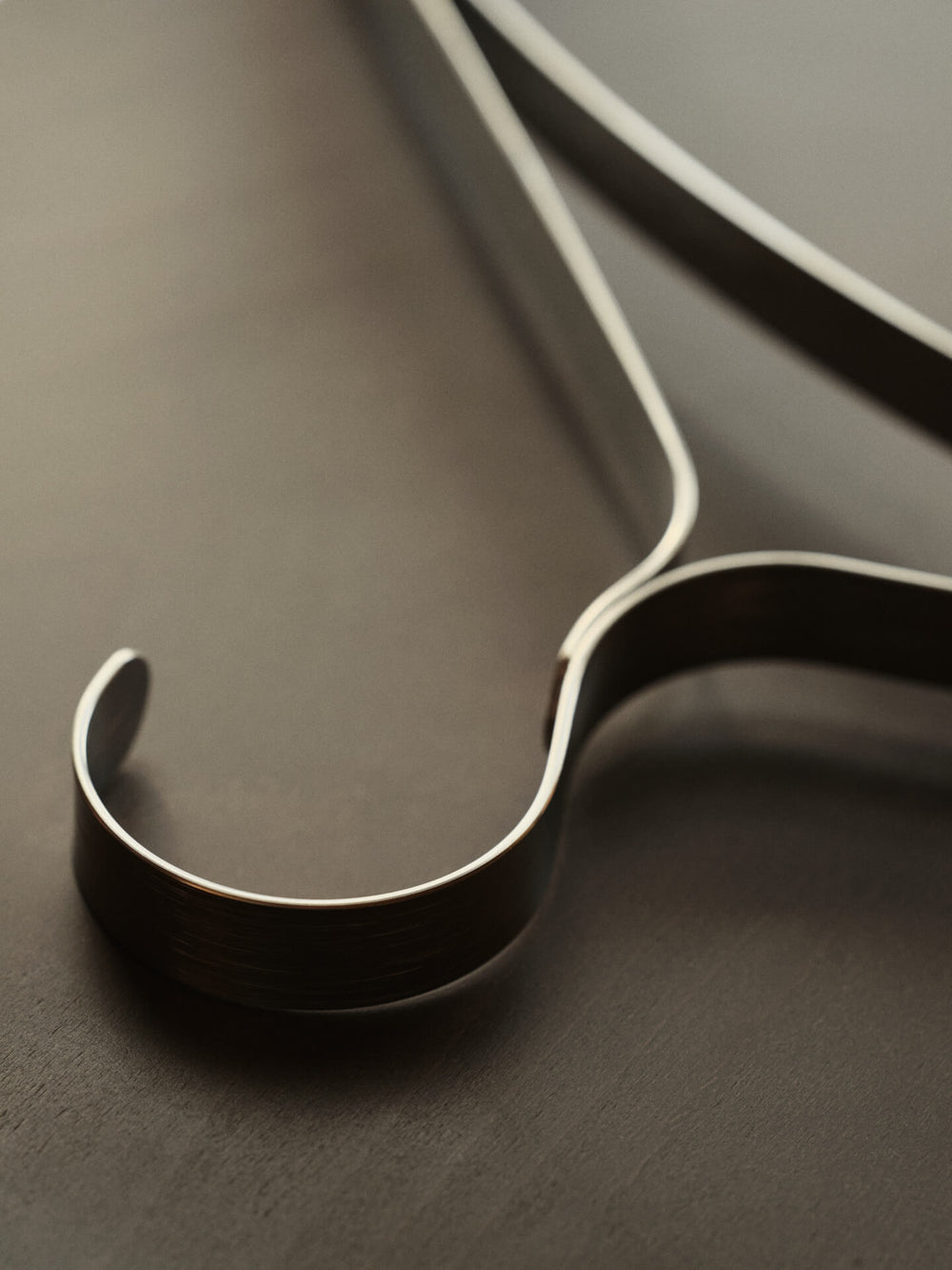 Close-up of the hanger's curved hook and bent steel profile