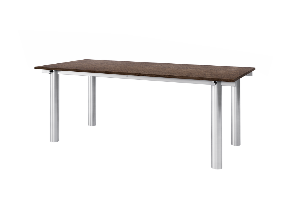 Dining table seen at an angle, dark stained oak top on a brushed stainless steel frame