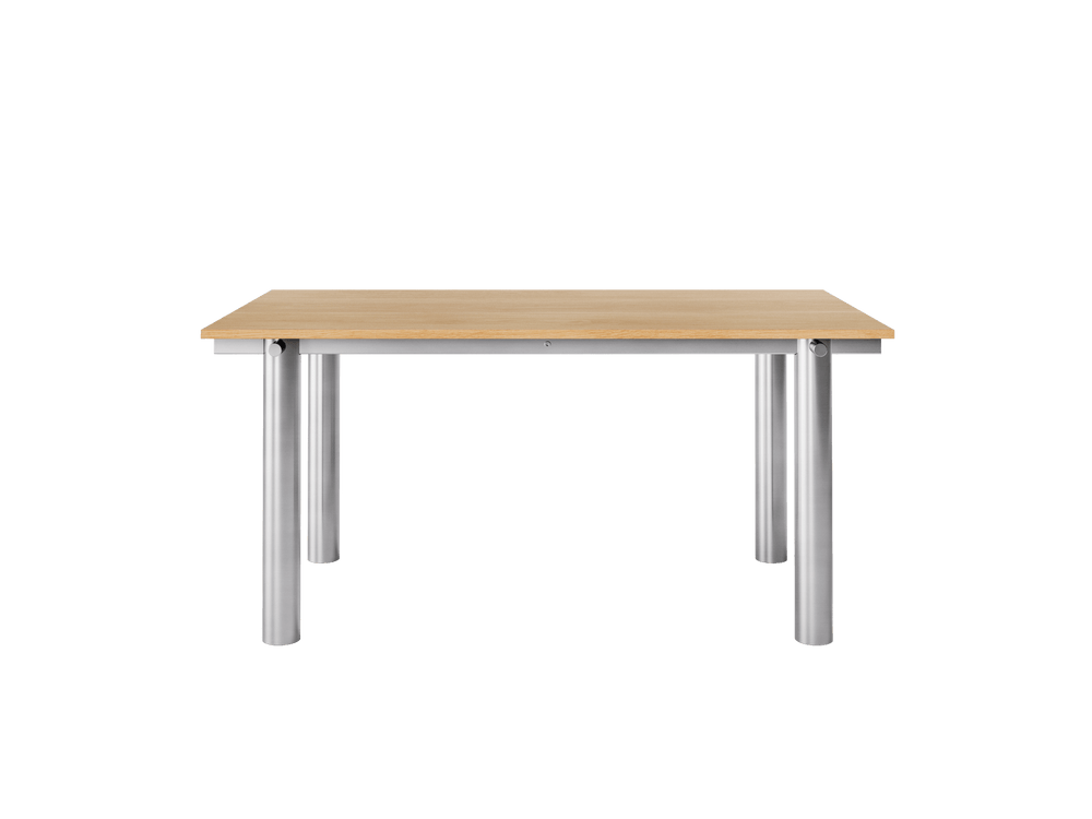 Dining table with natural oak veneer top on brushed stainless steel cylindrical legs, side view